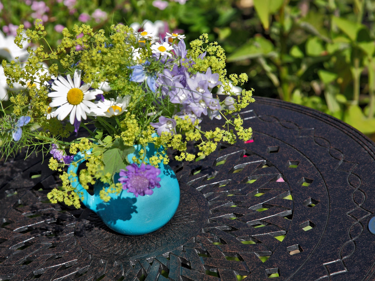 How do I maintain and protect black metal garden furniture?