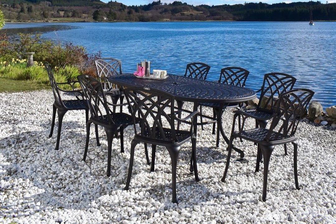 Oval dining table and 8 chairs by lazy susan in The cottage by the loch