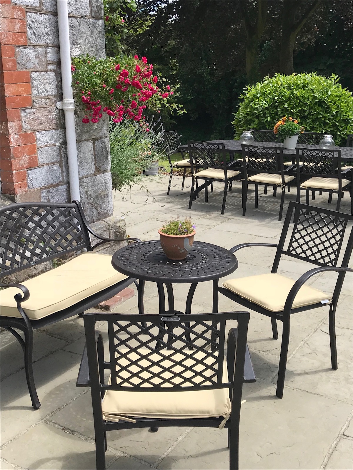 What are the advantages of buying a garden table set over individual pieces of garden furniture?