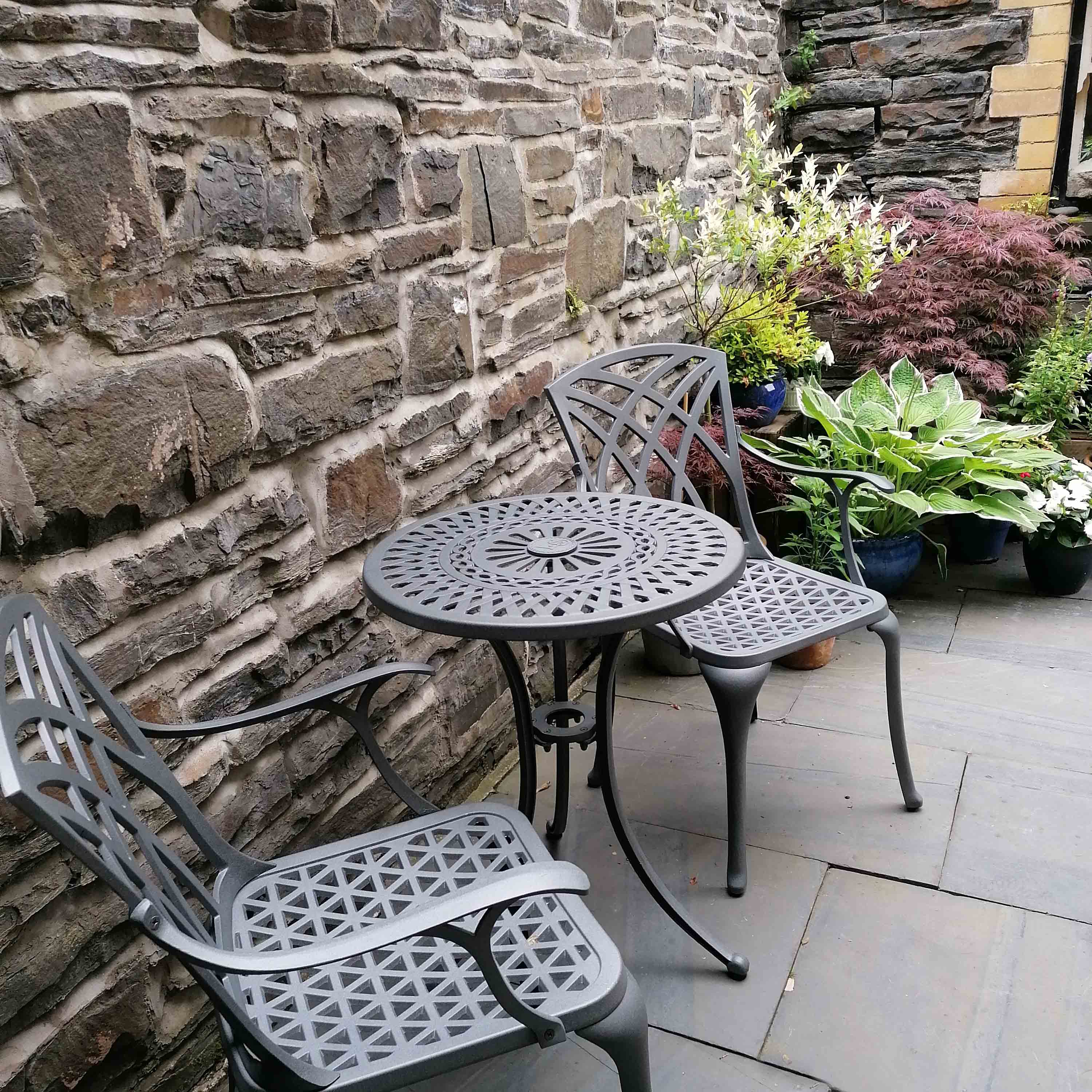 Add visual appeal with Eve small garden chairs and table