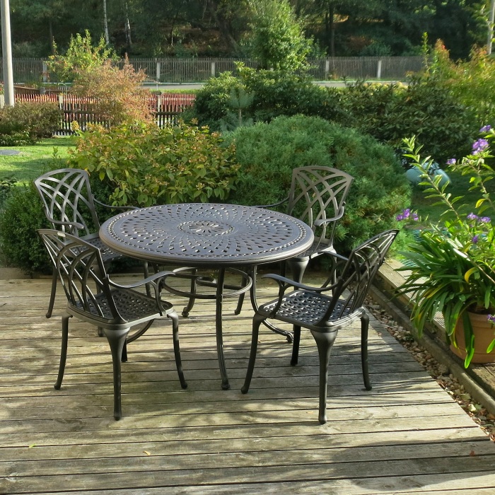 GGartentisch-Set in klassischem Schwarz auf einer Terrasse von Pflanzen umgeben
