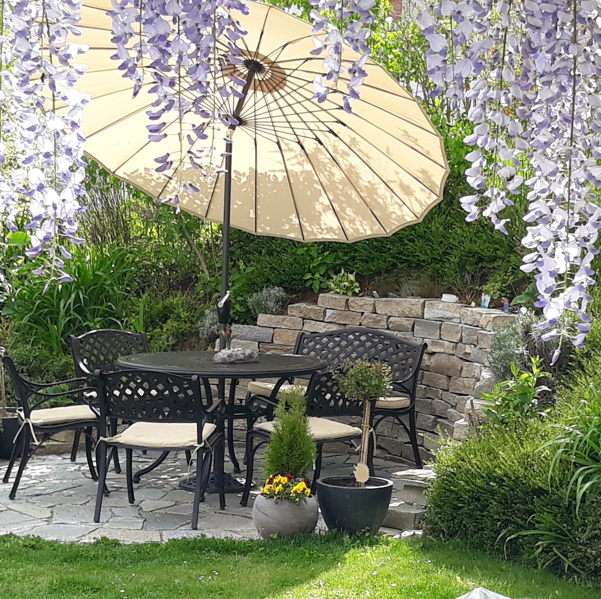 Pair your patio table and chairs with a parasol and cushions